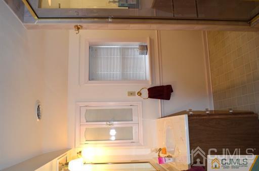 596 Old Post Road Edison, NJ 08817 - Photo 7 of 13 a bathroom with a sink and a mirror