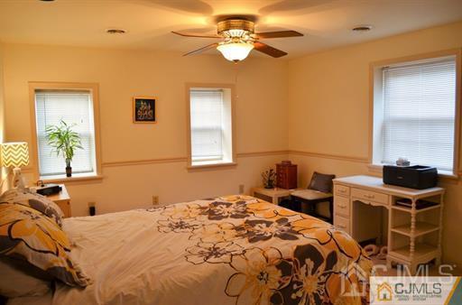 596 Old Post Road Edison, NJ 08817 - Photo 8 of 13 a bedroom with a bed and a window