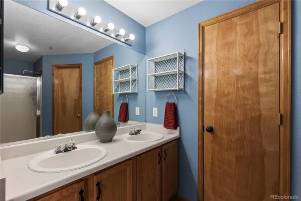 a bathroom with a sink double vanity and shower