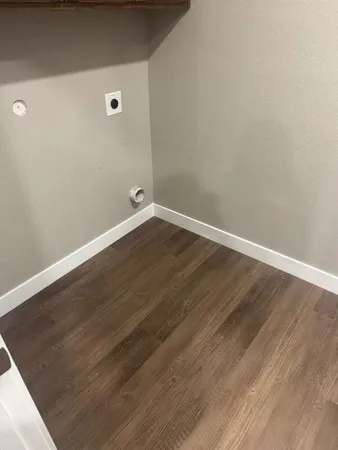 an empty room with wooden floor