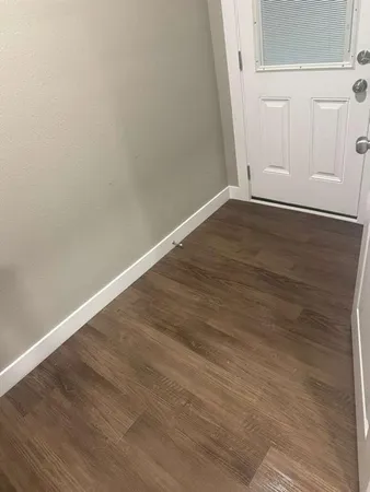 an empty room with wooden floor