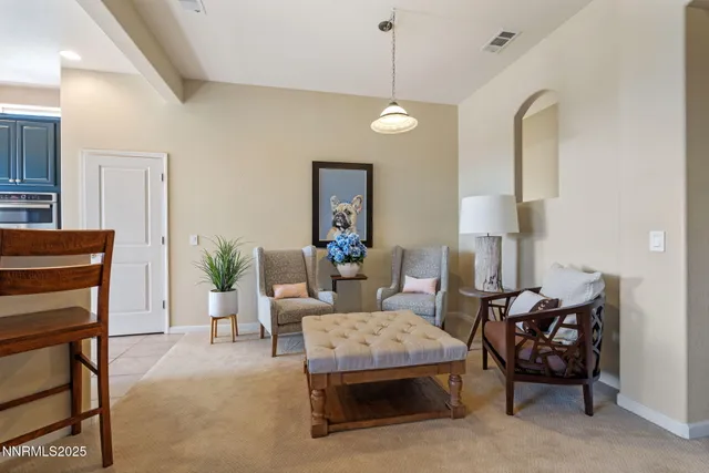 a living room with furniture and a lamp