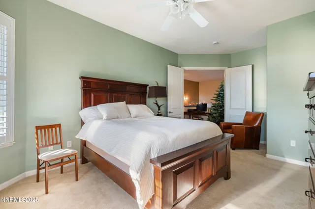 a bed room with a bed and a chair