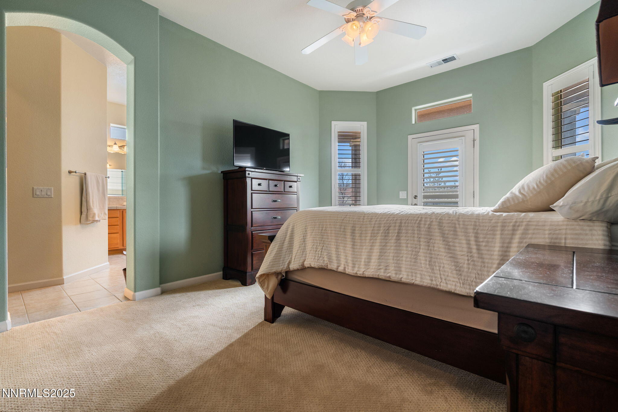 9900 Wilbur May Parkway, Unit 906 Reno, NV 89521 - Photo 23 of 44 a bedroom with a bed and a flat screen tv