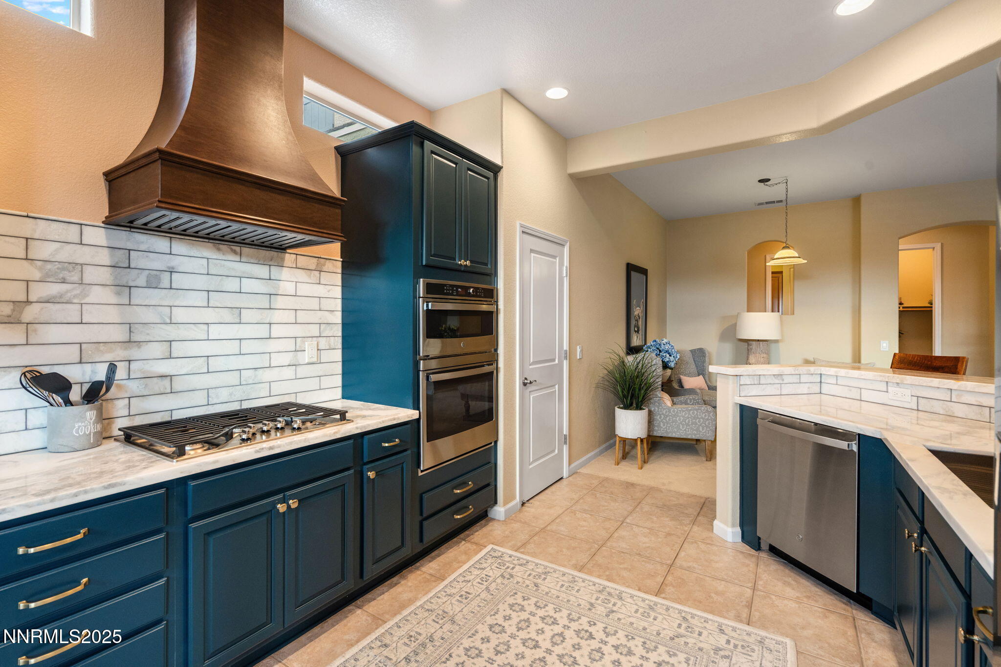 9900 Wilbur May Parkway, Unit 906 Reno, NV 89521 - Photo 3 of 44 a kitchen with stainless steel appliances kitchen island granite countertop a stove and cabinets