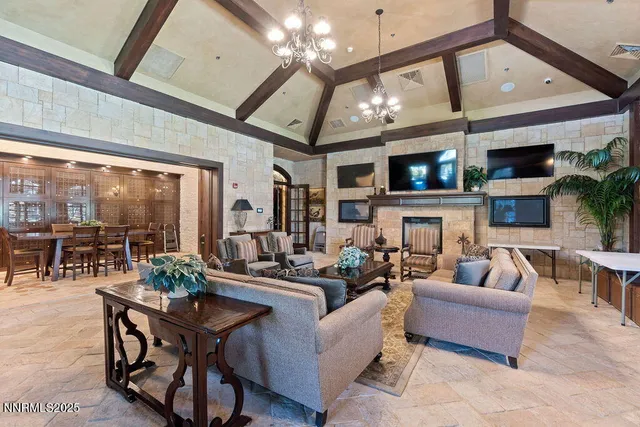 a living room with fireplace furniture and a large window