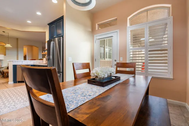 a dining room with furniture and wooden floor