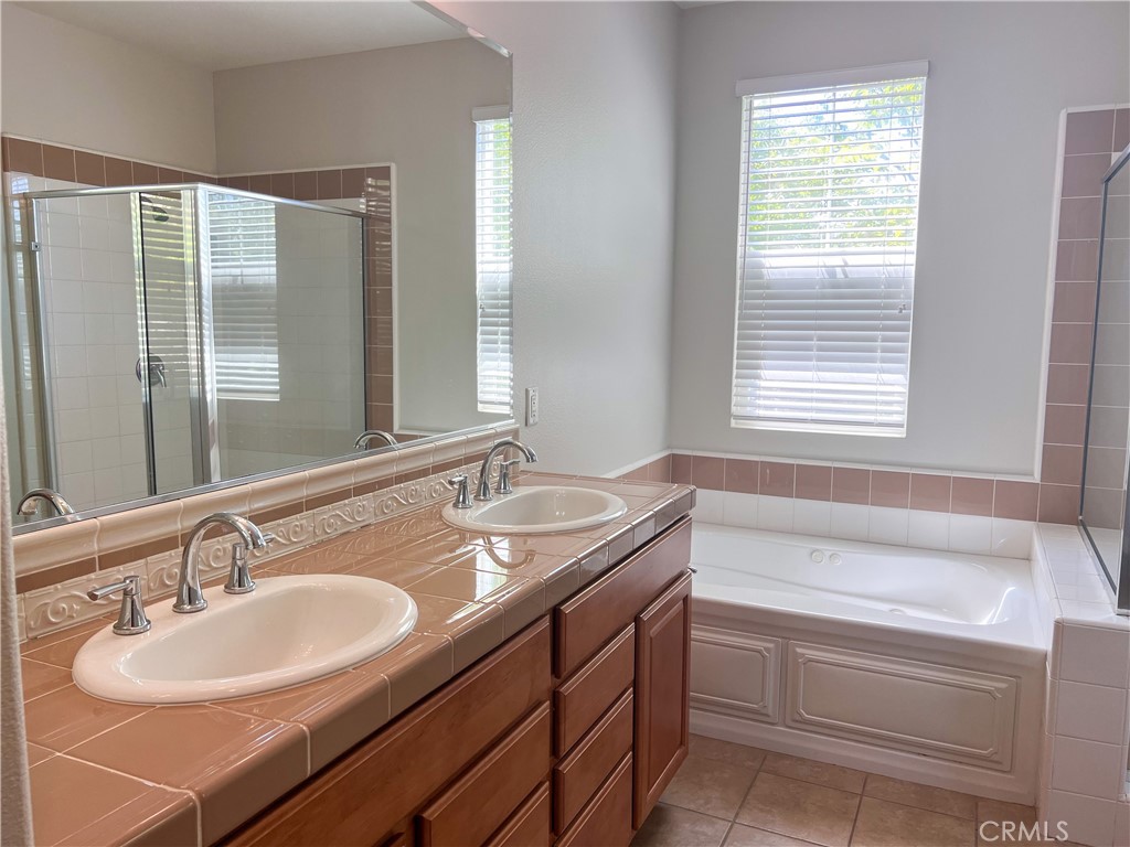 3 Paddock Place Ladera Ranch, CA 92694 - Photo 16 of 58 a bathroom with a granite countertop sink and a bathtub