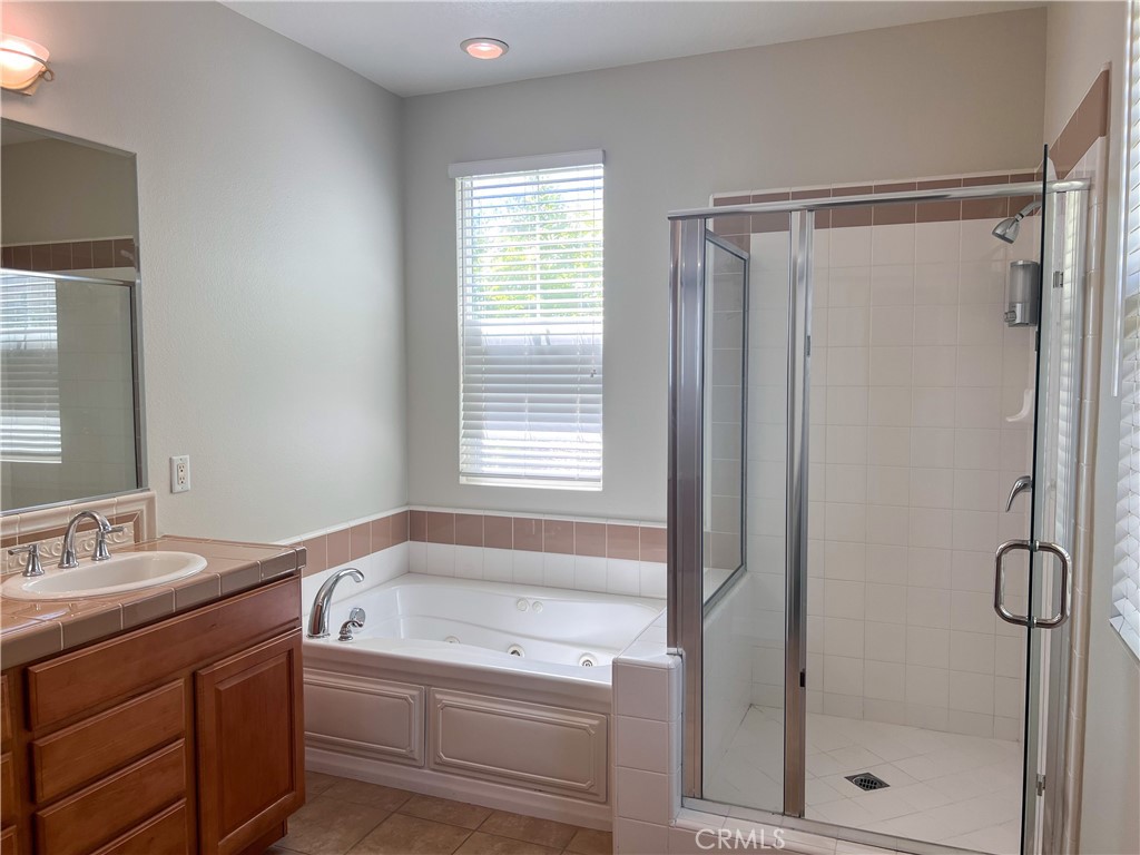 3 Paddock Place Ladera Ranch, CA 92694 - Photo 18 of 58 a bathroom with a granite countertop sink a toilet and shower
