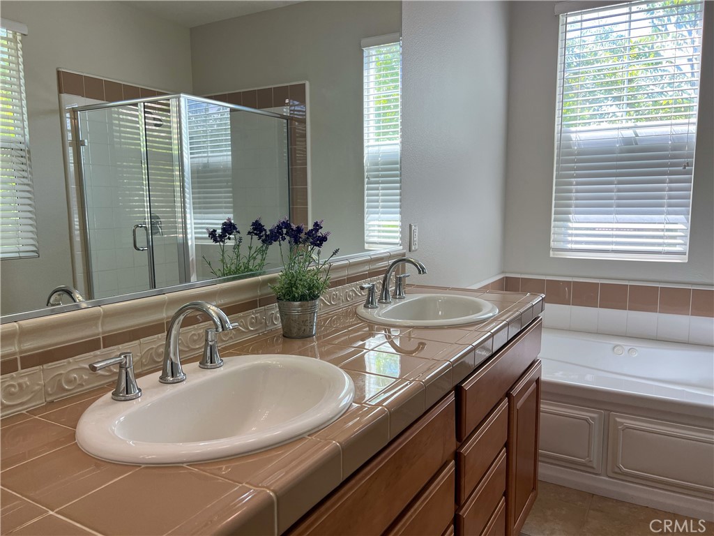 3 Paddock Place Ladera Ranch, CA 92694 - Photo 31 of 58 a bathroom with a granite countertop sink and a mirror