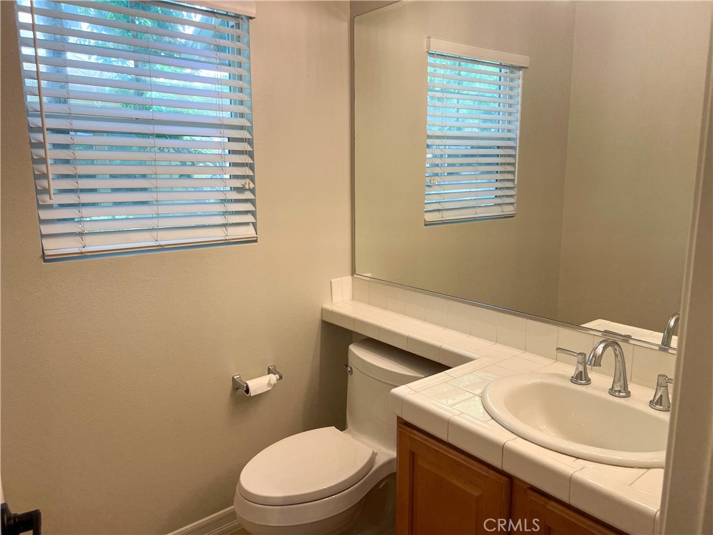 3 Paddock Place Ladera Ranch, CA 92694 - Photo 10 of 58 a bathroom with a toilet sink vanity and mirror