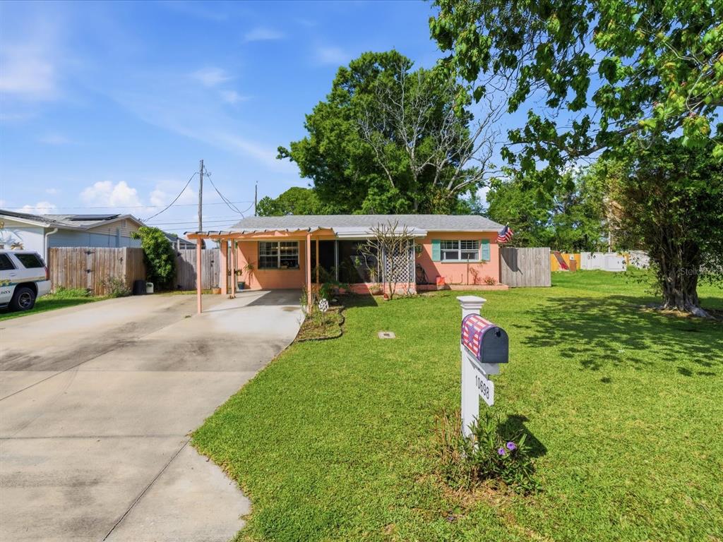 10698 106th Street Largo, FL 33778 - Photo 1 of 1 a front view of a house with a yard table and chairs