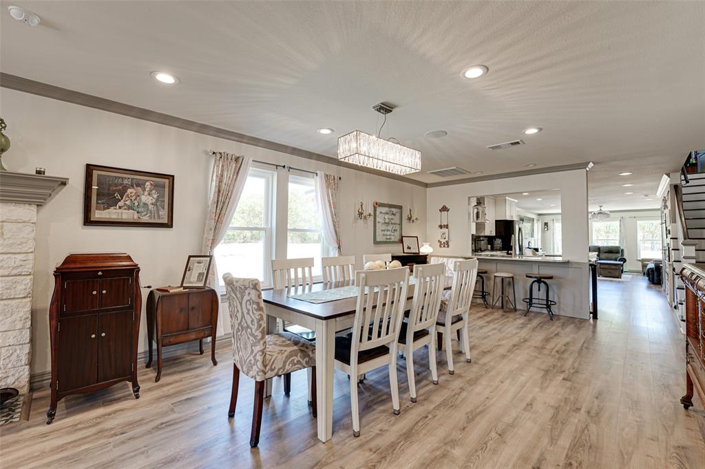 521 Bakers Branch Road Waxahachie, TX 75167 - Photo 11 of 37 Spacious dining area featuring wood-finish flooring, recessed lighting, and a linear crystal chandelier