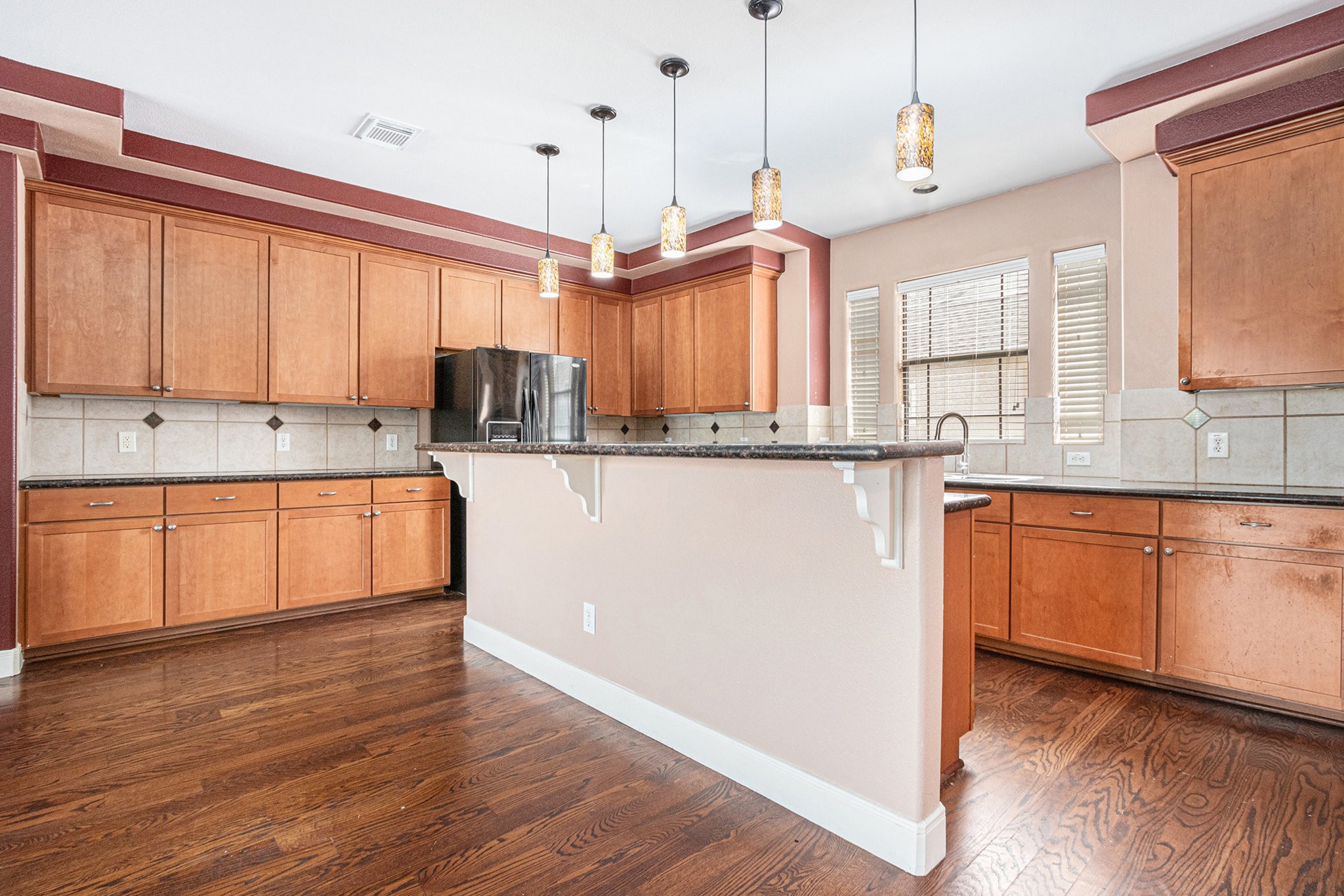2402 Calumet Street, Unit B Houston, TX 77004 - Photo 14 of 44 a kitchen with stainless steel appliances granite countertop a sink a stove and a wooden floors