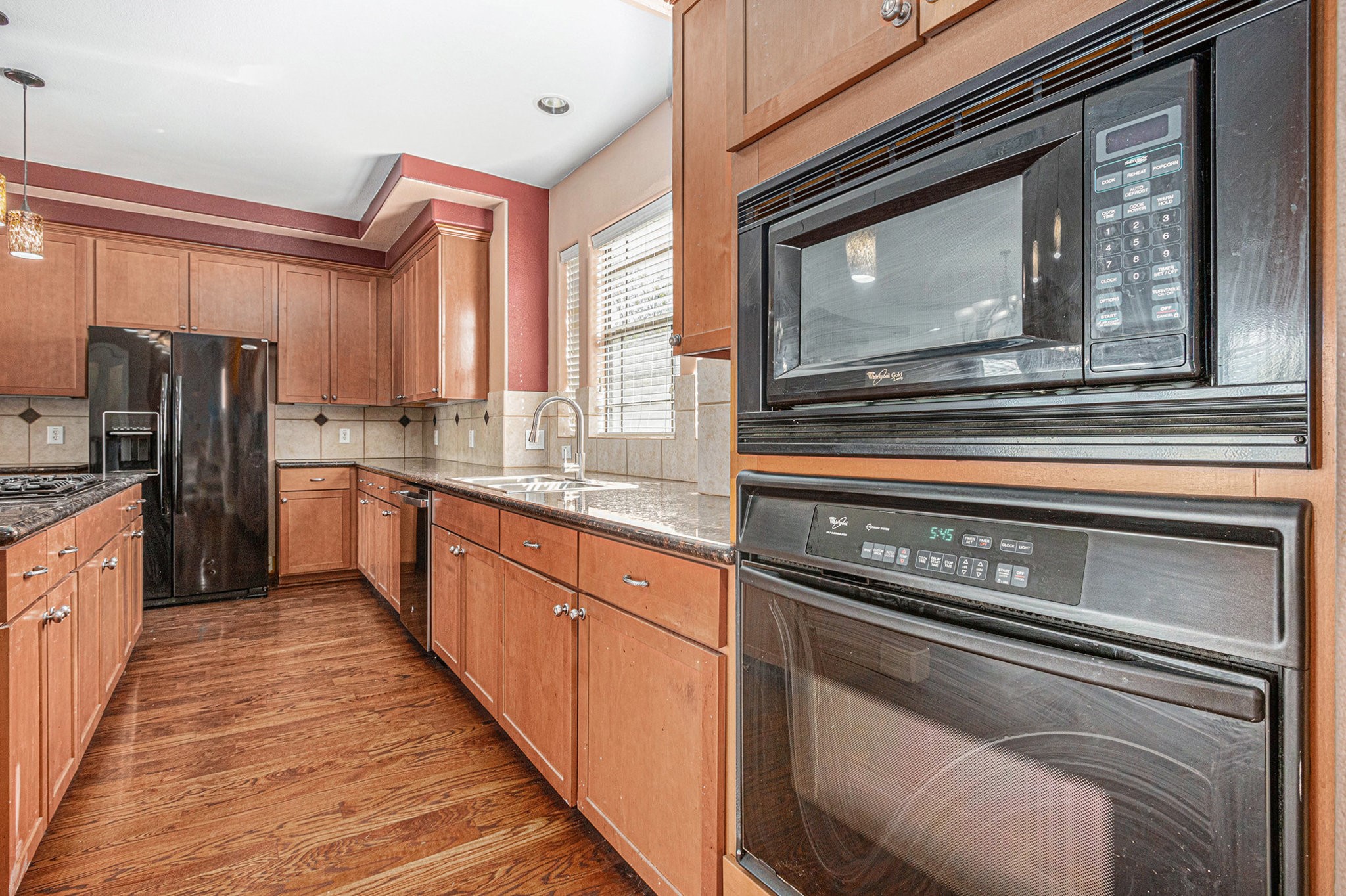 2402 Calumet Street, Unit B Houston, TX 77004 - Photo 15 of 44 a kitchen with stainless steel appliances granite countertop a stove microwave and refrigerator