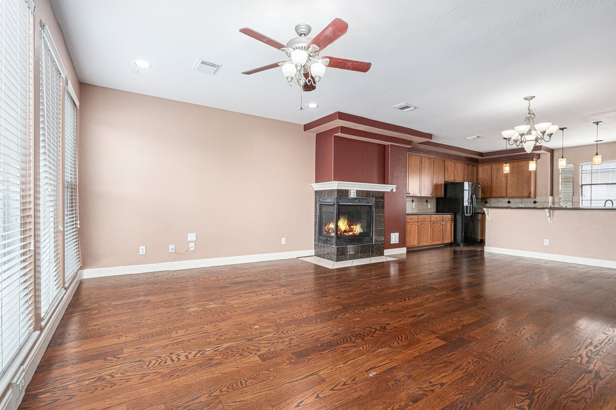 2402 Calumet Street, Unit B Houston, TX 77004 - Photo 7 of 44 a view of a livingroom with a fireplace a chandelier fan and wooden floor