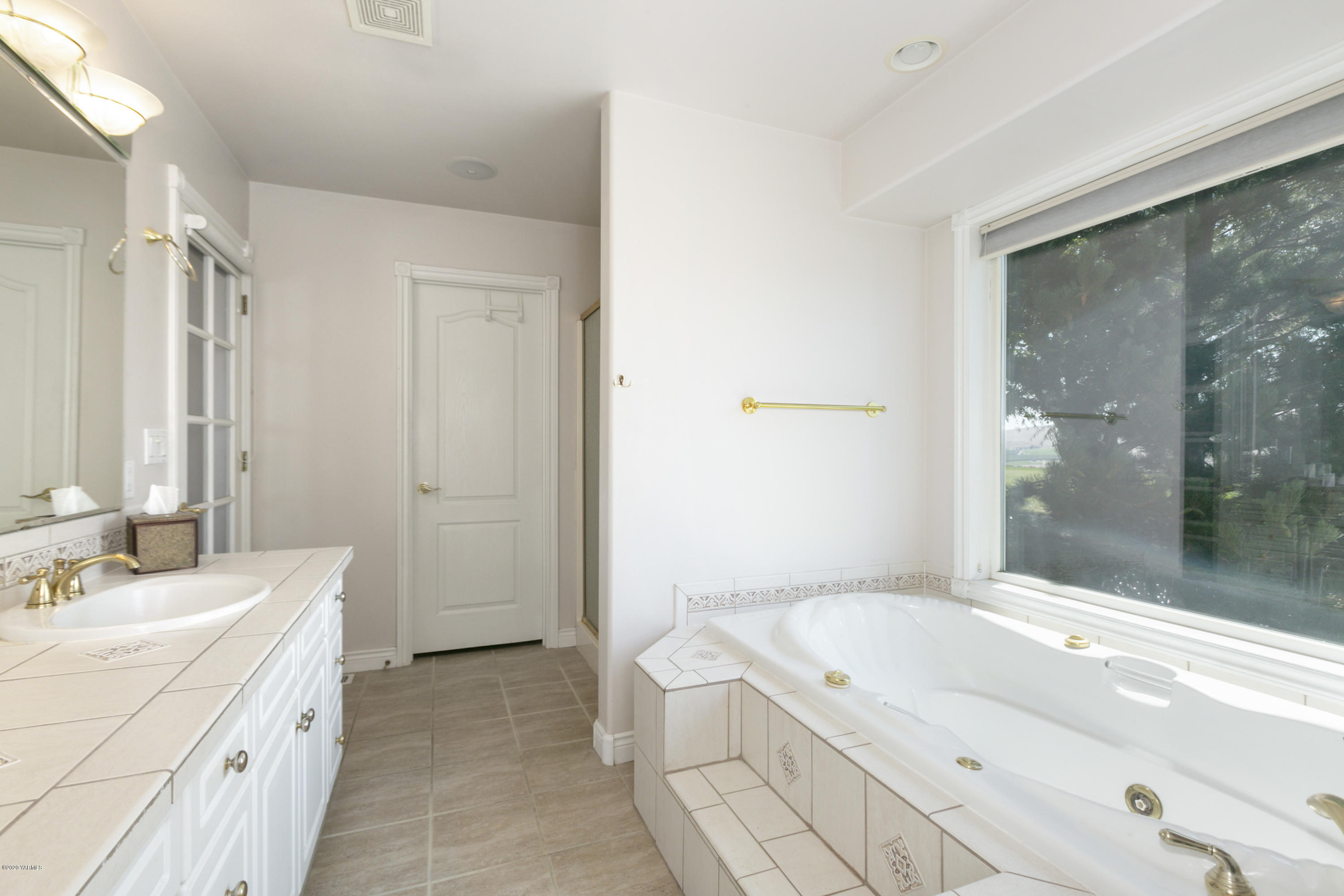 229 Konnowac Pass Road Moxee, WA 98936 - Photo 16 of 25 a spacious bathroom with a granite countertop sink a toilet and shower
