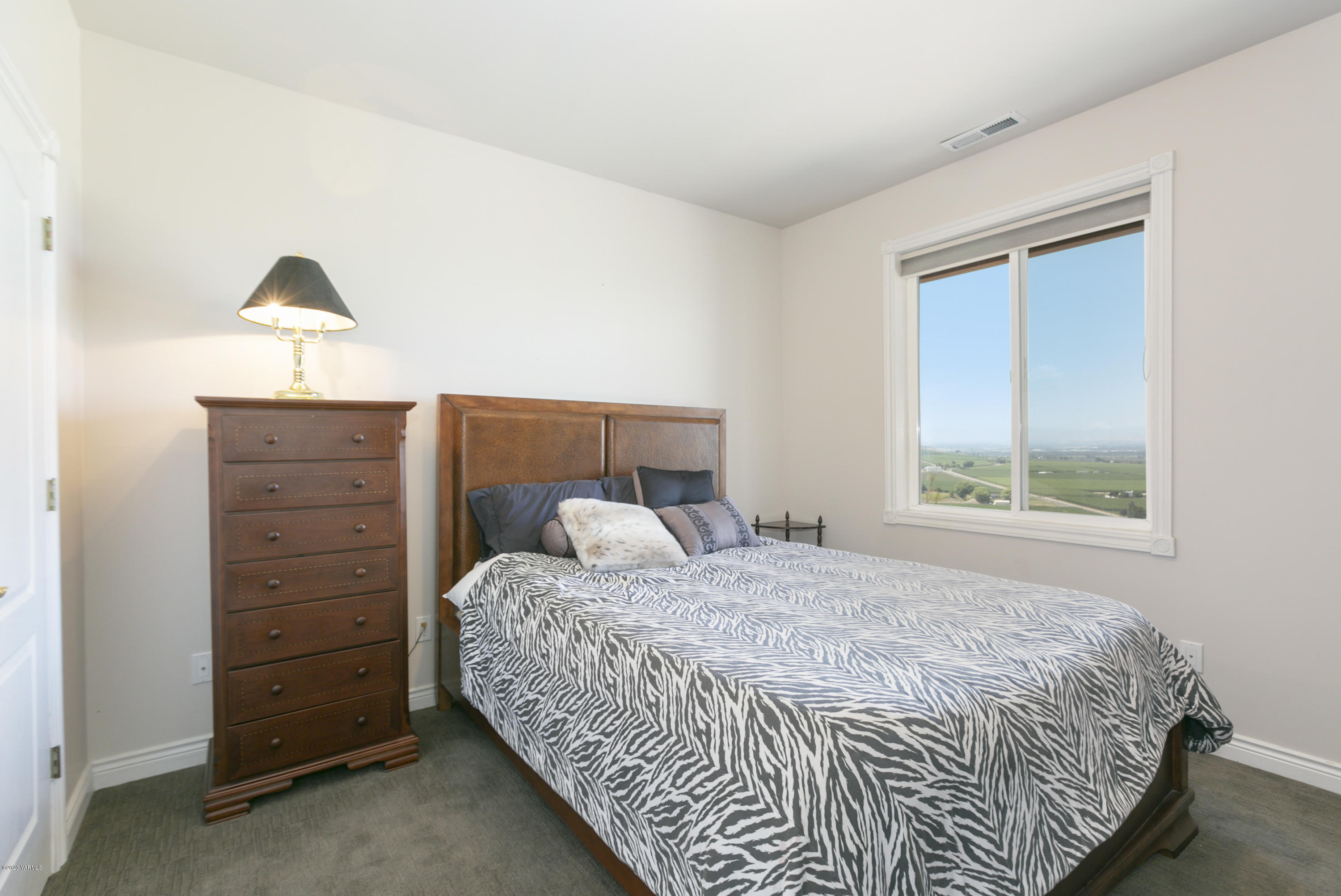 229 Konnowac Pass Road Moxee, WA 98936 - Photo 19 of 25 a bedroom with a bed and a window