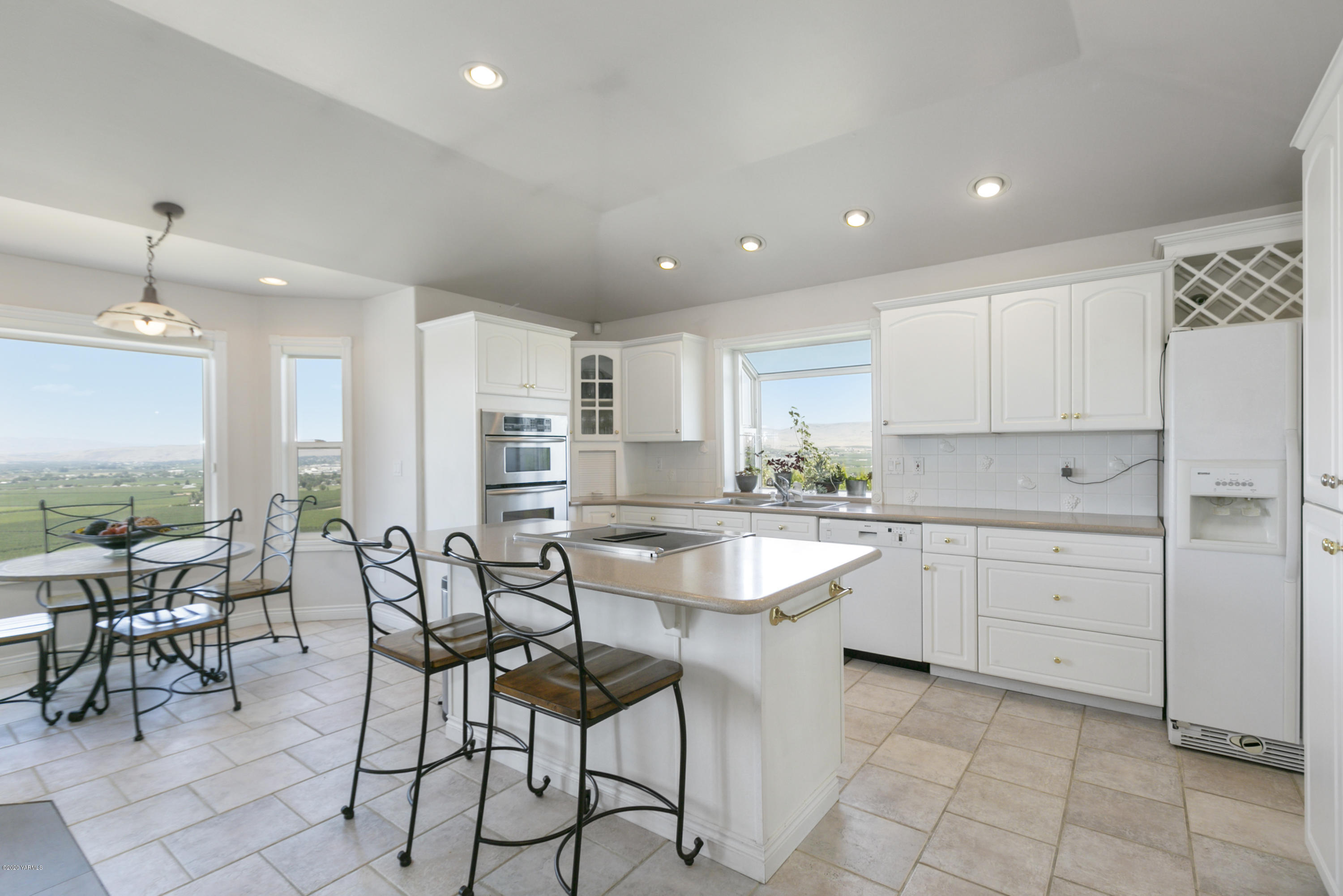 229 Konnowac Pass Road Moxee, WA 98936 - Photo 9 of 25 a kitchen with sink and chairs