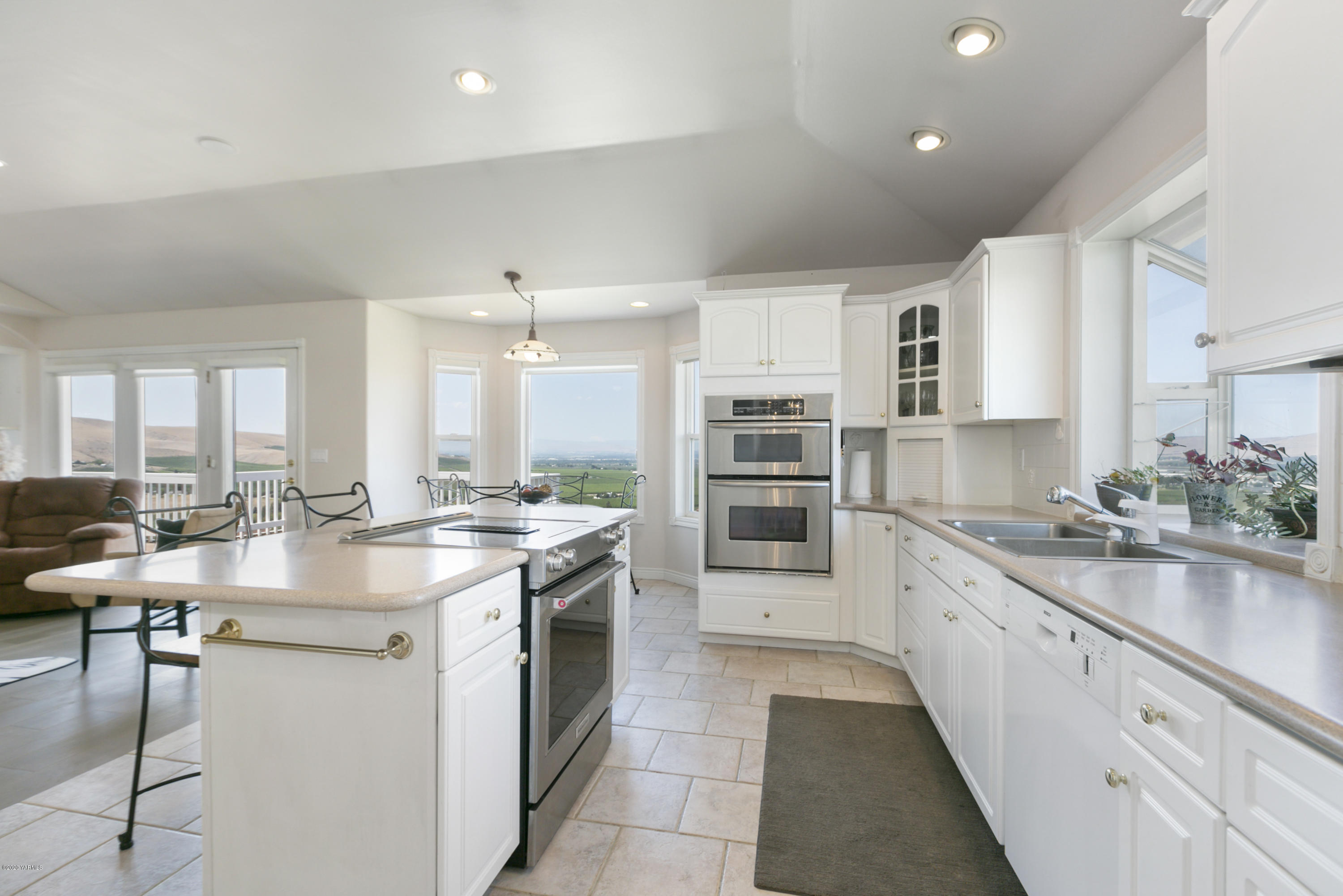 229 Konnowac Pass Road Moxee, WA 98936 - Photo 10 of 25 a kitchen with a sink stove and cabinets