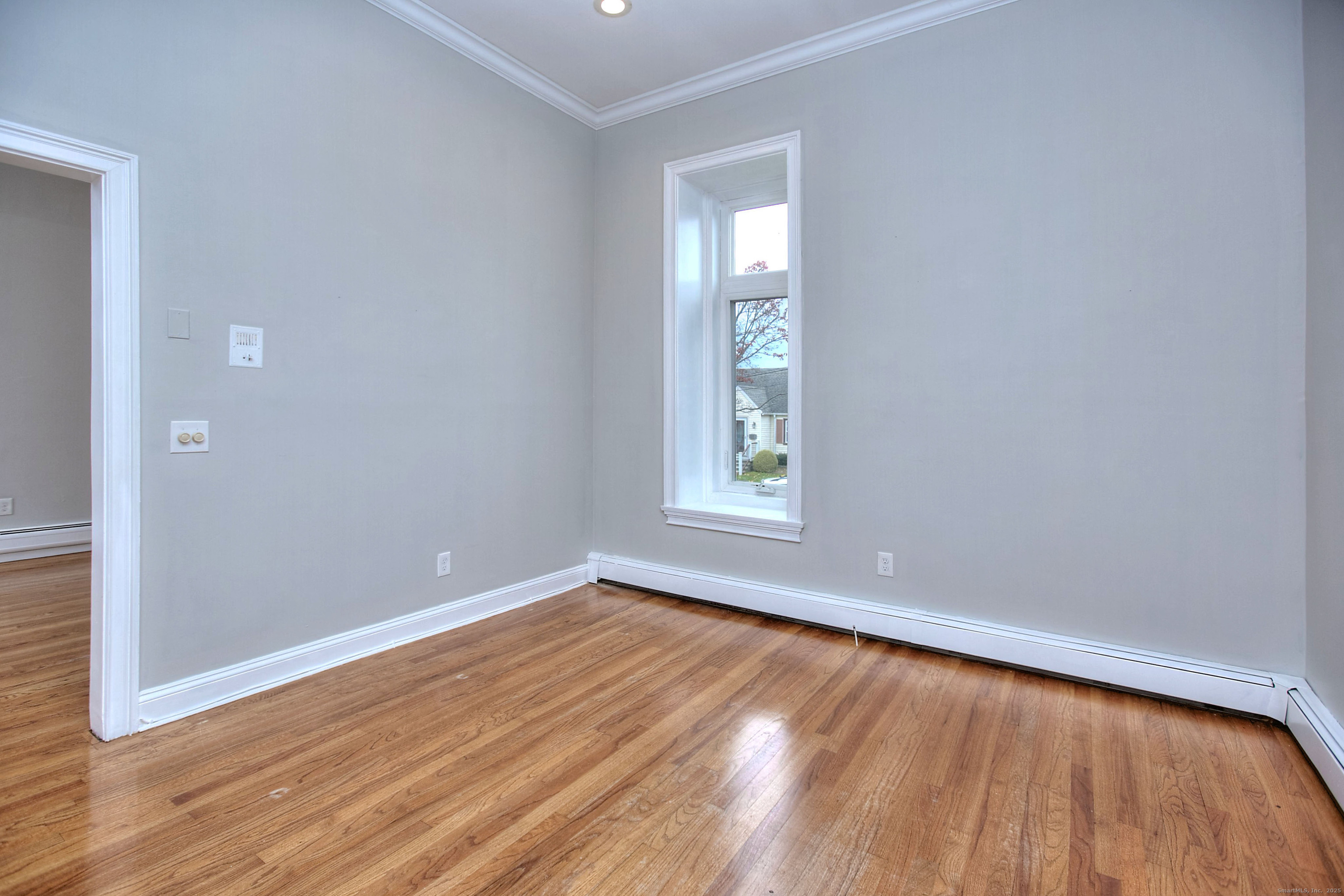300 Soundview Avenue Fairfield, CT 06825 - Photo 12 of 28 an empty room with wooden floor and windows