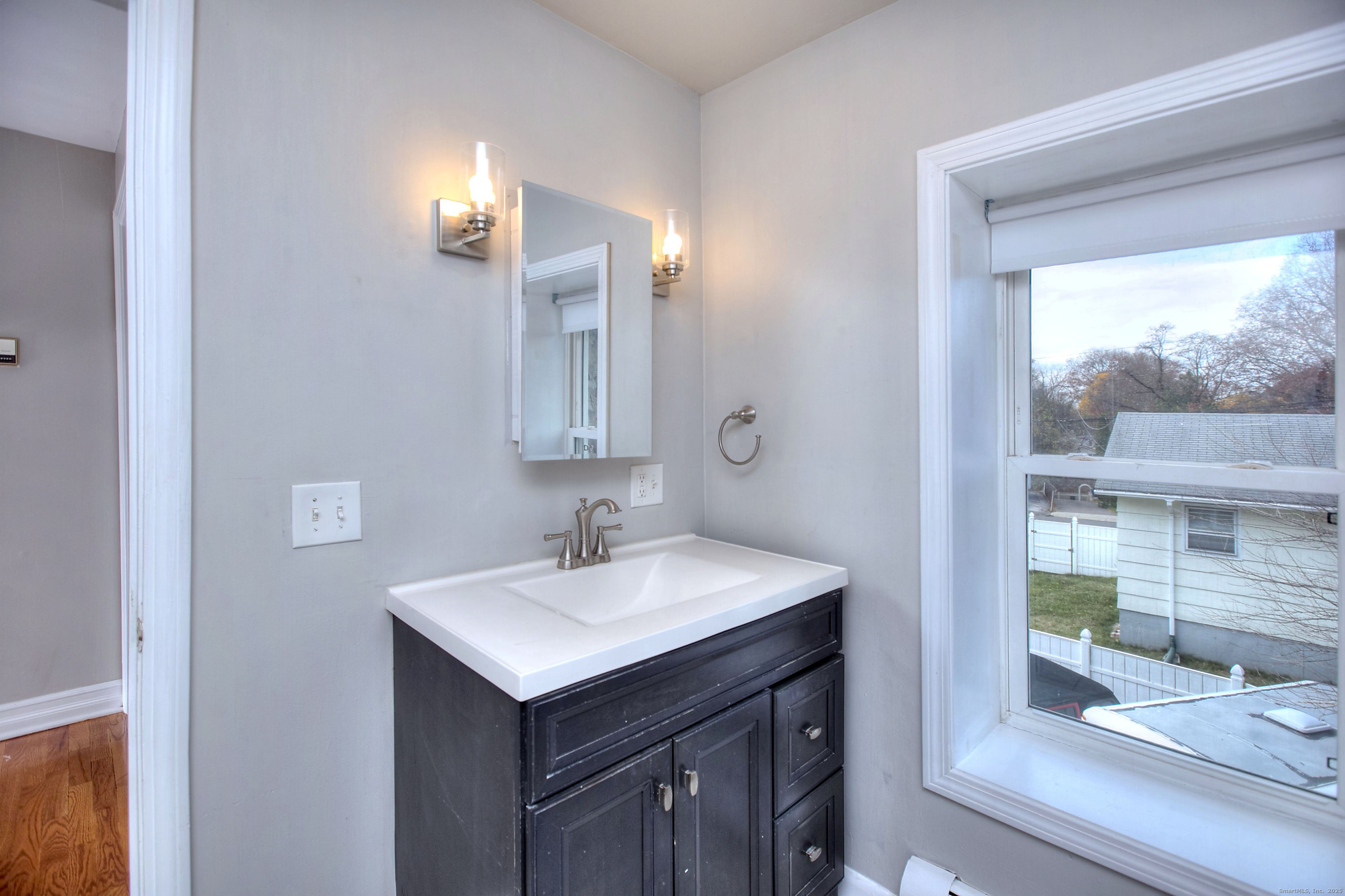 300 Soundview Avenue Fairfield, CT 06825 - Photo 14 of 28 a bathroom with a sink and a mirror