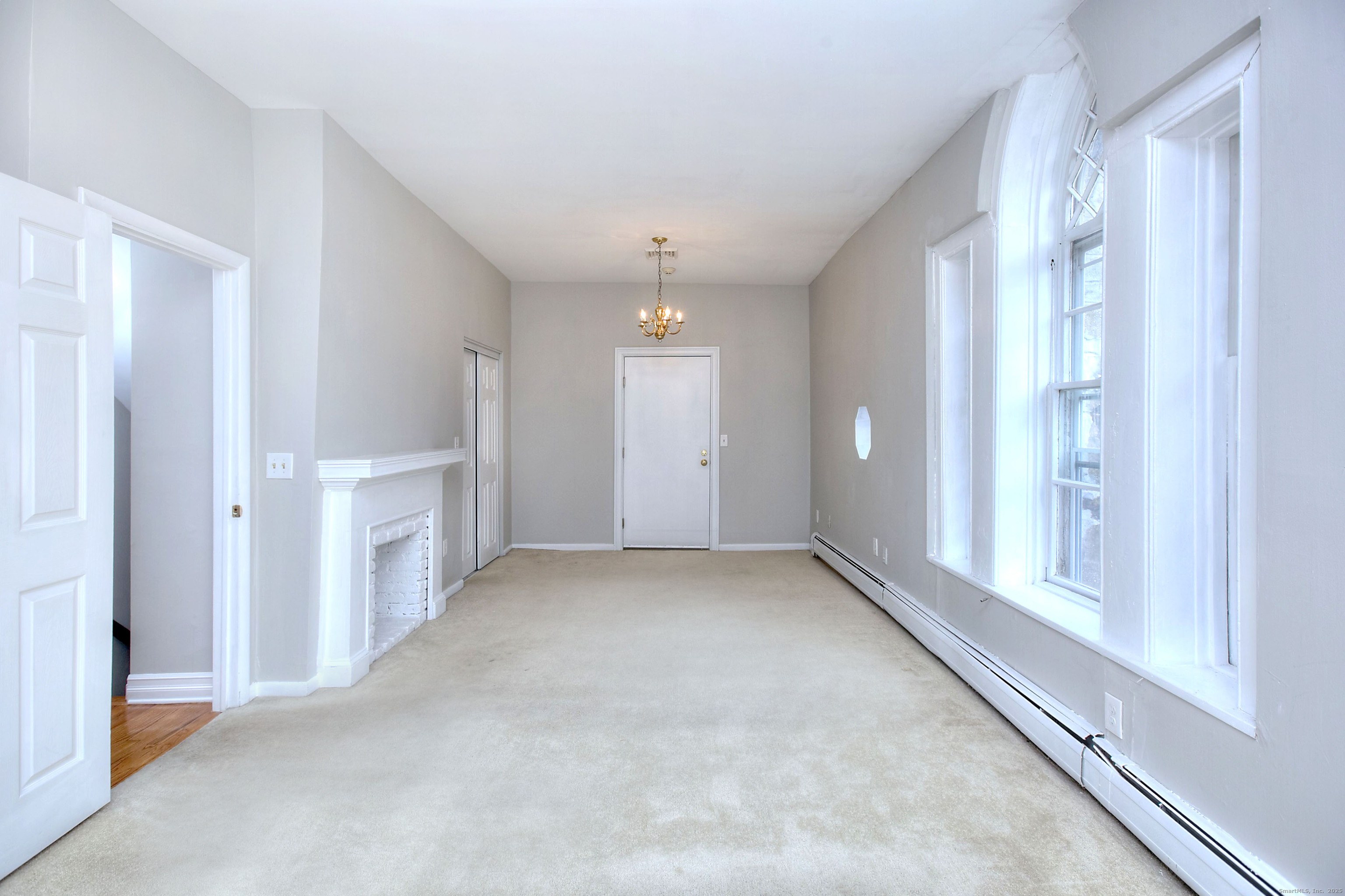 300 Soundview Avenue Fairfield, CT 06825 - Photo 18 of 28 an empty room with windows and pillars in it