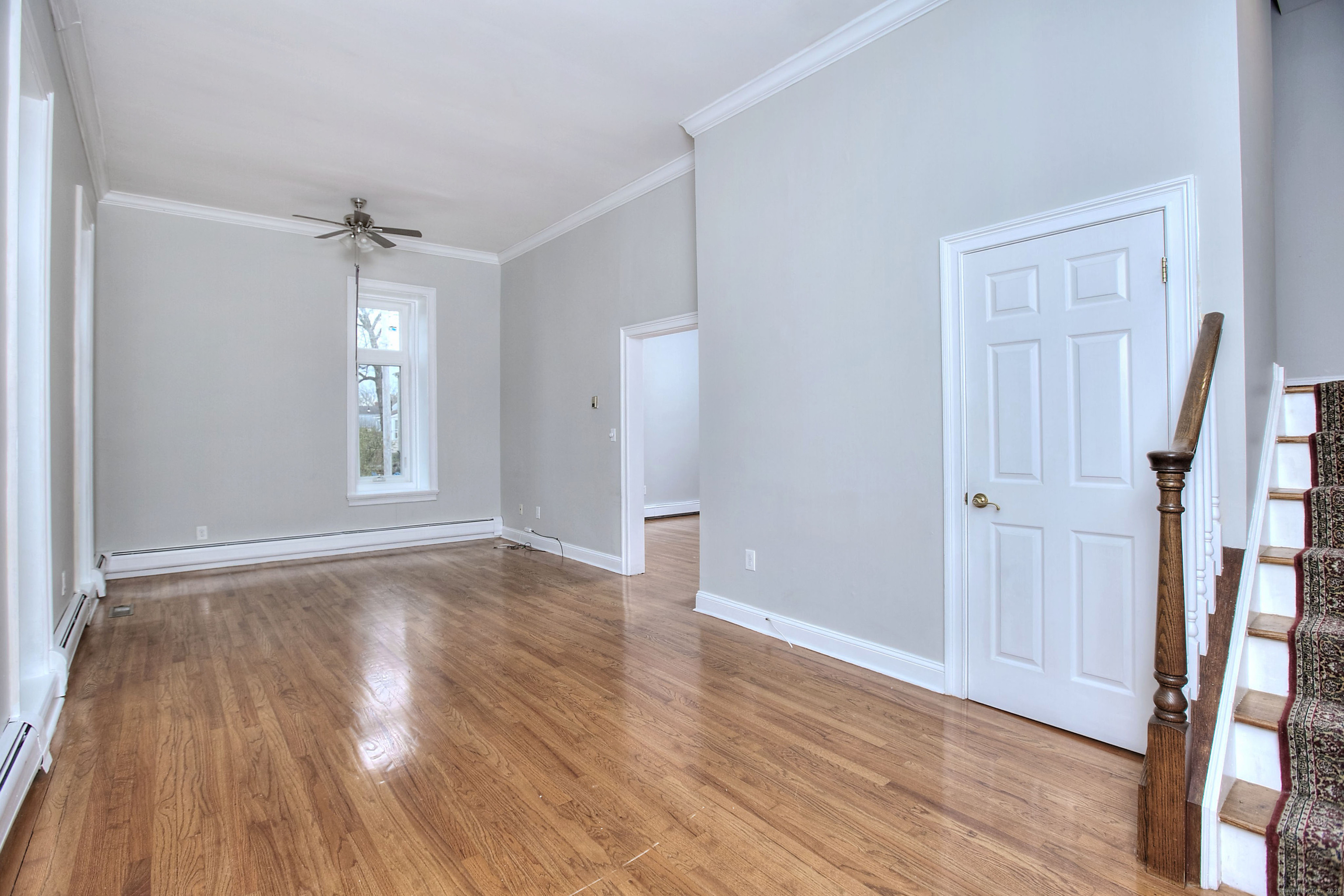 300 Soundview Avenue Fairfield, CT 06825 - Photo 4 of 28 a view of empty room with wooden floor and fan