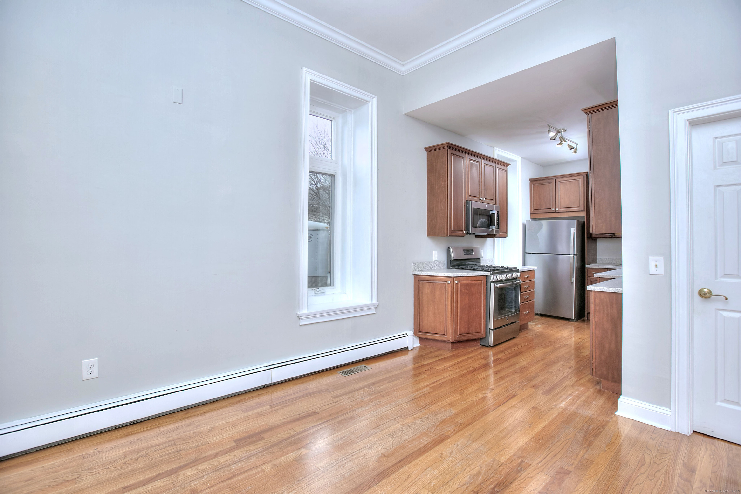 300 Soundview Avenue Fairfield, CT 06825 - Photo 8 of 28 a kitchen with stainless steel appliances granite countertop a stove a sink and a refrigerator with wooden floors