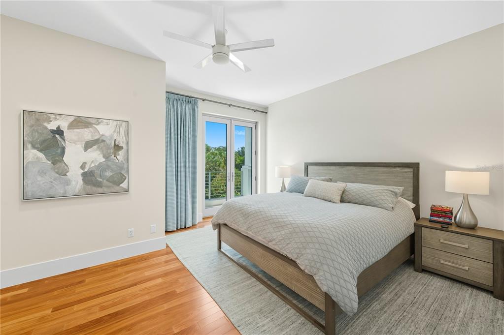 3315 Bay Shore Road Sarasota, FL 34234 - Photo 37 of 96 a spacious bedroom with a large bed and a chandelier
