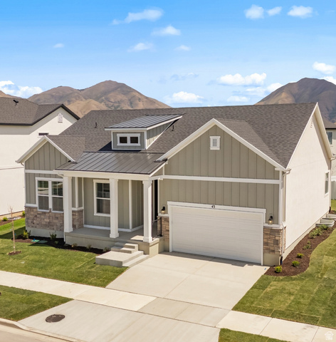 43 South Crimson Way, Unit 311 Mapleton, UT 84664 - Photo 3 of 28 Contemporary craftsman-style residence featuring a combination of horizontal and vertical siding, stone accents, and a covered porch with white columns