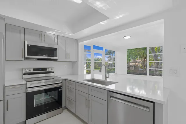 a kitchen with granite countertop a stove and a sink