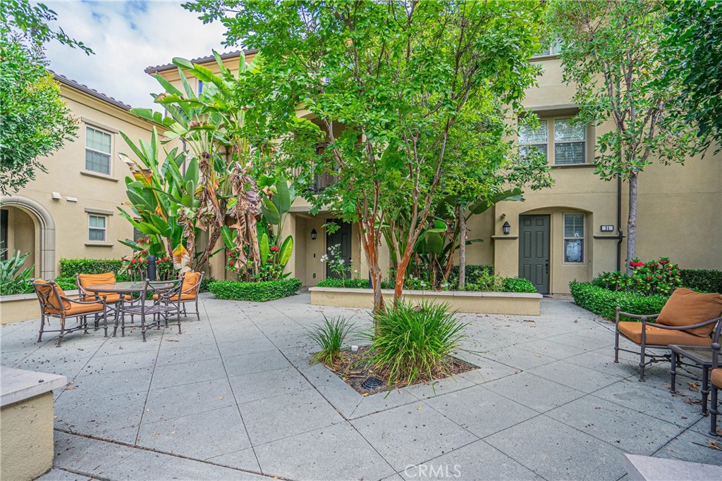 a view of a patio with table and chairs and potted plants