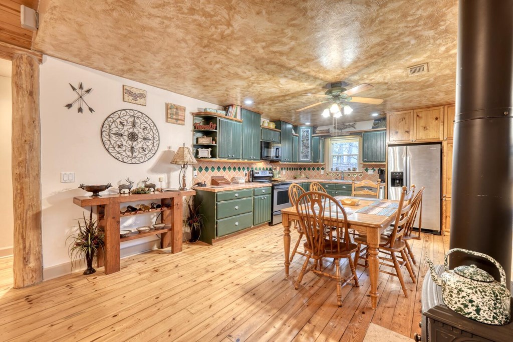 4868 Swallows Creek Road Hiawassee, GA 30546 - Photo 16 of 59 a view of a dining room with furniture and a table