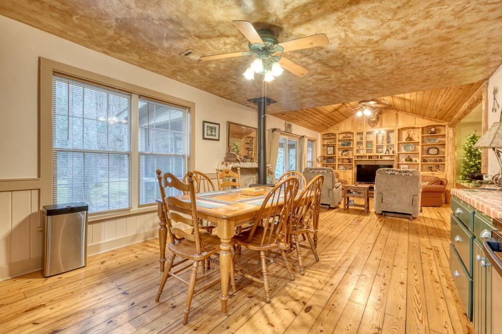 4868 Swallows Creek Road Hiawassee, GA 30546 - Photo 18 of 59 a view of a dining room with furniture and wooden floor
