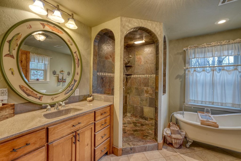 4868 Swallows Creek Road Hiawassee, GA 30546 - Photo 26 of 59 a bathroom with a sink and a mirror