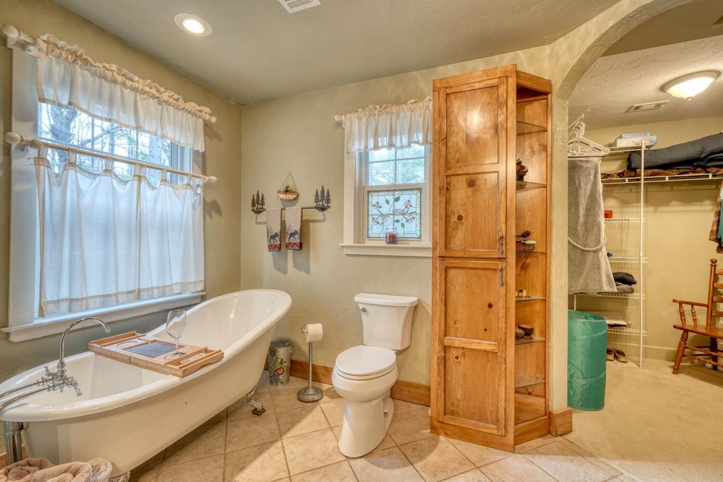 4868 Swallows Creek Road Hiawassee, GA 30546 - Photo 28 of 59 a bathroom with a granite countertop sink toilet and shower