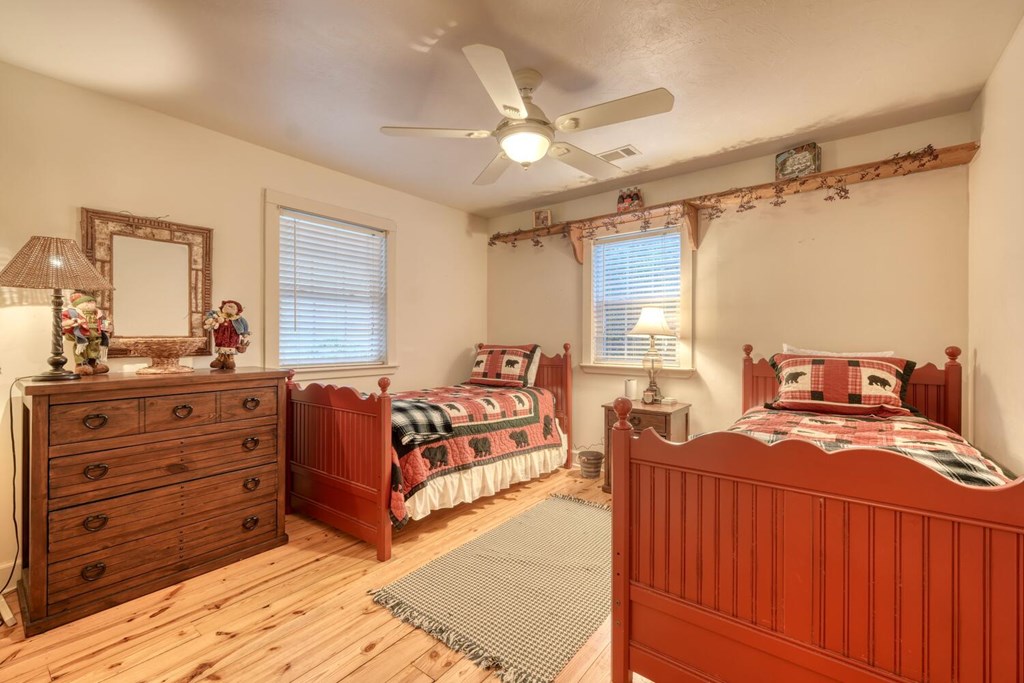 4868 Swallows Creek Road Hiawassee, GA 30546 - Photo 29 of 59 a bedroom with a bed and a dresser