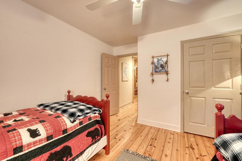 4868 Swallows Creek Road Hiawassee, GA 30546 - Photo 30 of 59 a bedroom with a bed and wooden floor