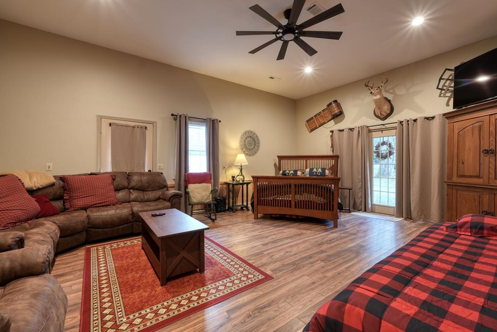 4868 Swallows Creek Road Hiawassee, GA 30546 - Photo 32 of 59 a living room with furniture and a flat screen tv