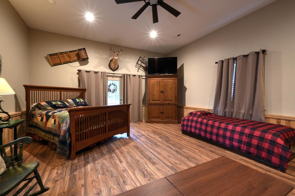 4868 Swallows Creek Road Hiawassee, GA 30546 - Photo 34 of 59 a bedroom with a bed window and a chandelier