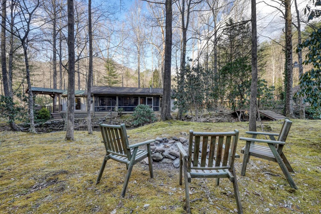 4868 Swallows Creek Road Hiawassee, GA 30546 - Photo 48 of 59 a view of a chairs and table in backyard