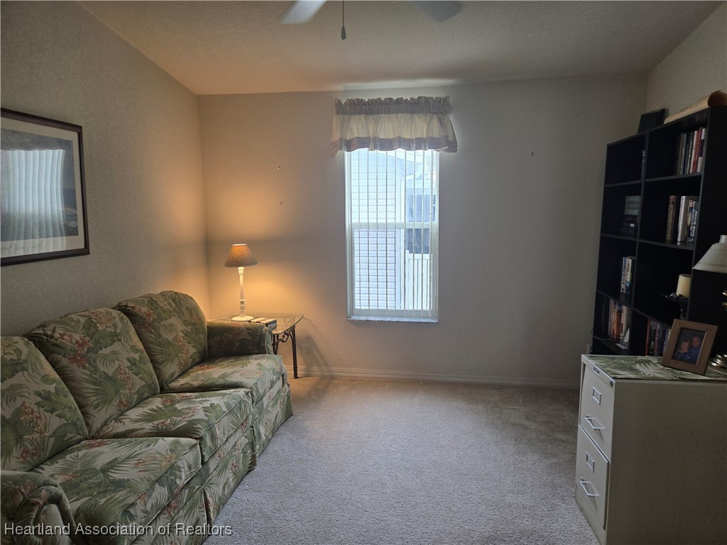 3312 Beartooth Pass Sebring, FL 33872 - Photo 14 of 39 a living room with furniture and a flat screen tv