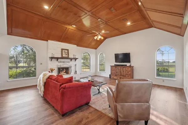 a living room with furniture a fireplace and a flat screen tv
