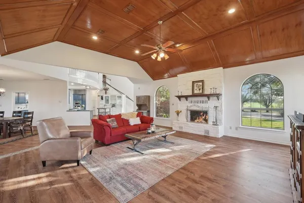 a living room with furniture a fireplace and a table