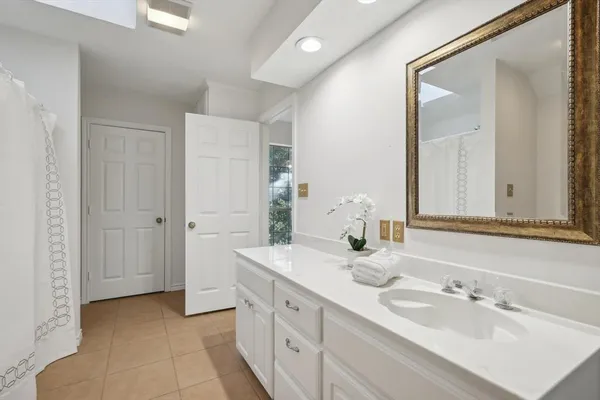 a spacious bathroom with a double vanity sink mirror and