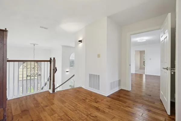 a view of an empty room and wooden floor