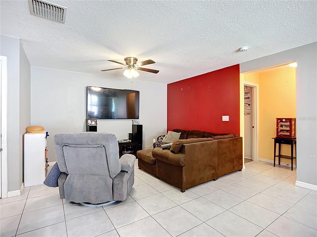 7707 Sunshine Bridge Avenue Gibsonton, FL 33534 - Photo 13 of 33 a living room with furniture and a flat screen tv