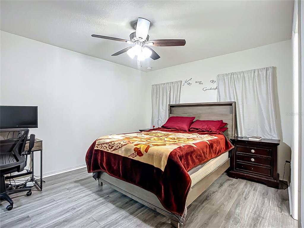 7707 Sunshine Bridge Avenue Gibsonton, FL 33534 - Photo 15 of 33 a bedroom with a bed and a chandelier