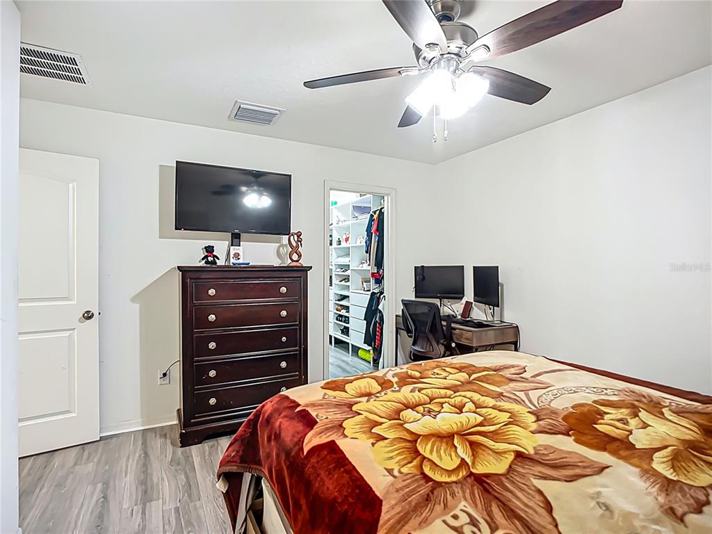 7707 Sunshine Bridge Avenue Gibsonton, FL 33534 - Photo 16 of 33 a bedroom with a bed and a flat tv screen on dresser